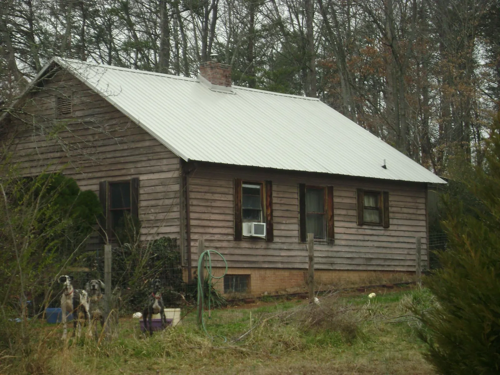 White metal roof on an old wood sided farmhouse, from a Metal Roof Installation job in Strongstown